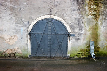 old forged gate on the facade of the building