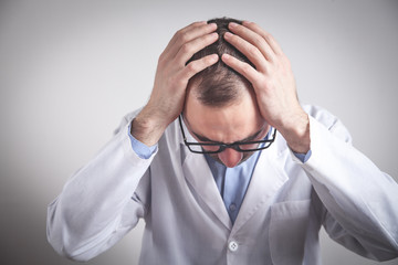 Wall Mural - Caucasian depressed doctor in clinic.