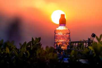 Close-up view of the water bottle placed on the table, the bokeh light of the beautiful evening light, the business concept of selling text products