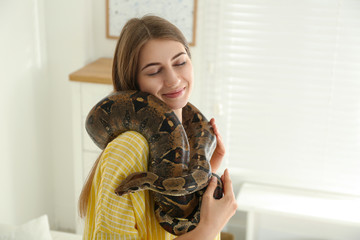 Sticker - Young woman with boa constrictor at home. Exotic pet