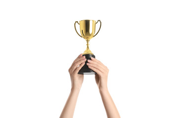 Woman holding gold trophy cup on white background, closeup