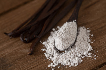 Sticker - vanilla beans with aromatic sugar on dark wooden surface