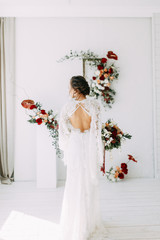  Decor of the ceremony with red roses. Portrait of the bride in the style of fine art. Wedding lace dress on the girl.