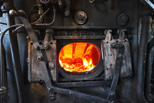 A Steam Engine Train Boiler With A Burning Fire
