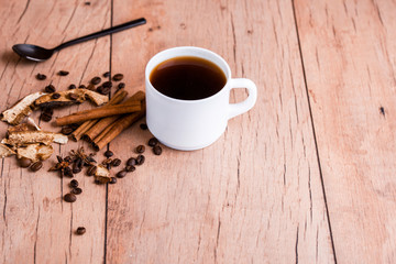 Wall Mural - Fragrant natural coffee with cinnamon sticks and a black spoon.