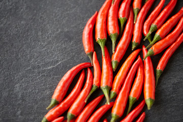 Wall Mural - cooking, food and culinary concept - red chili or cayenne pepper on slate stone surface