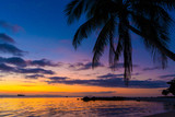 Fototapeta Zachód słońca - Colorful sunset on the ocean. Sunset meetings at the beach. Tropical sunset with palm trees