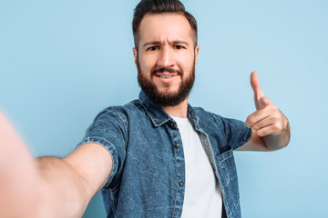 Wall Mural - A positive man takes a selfie