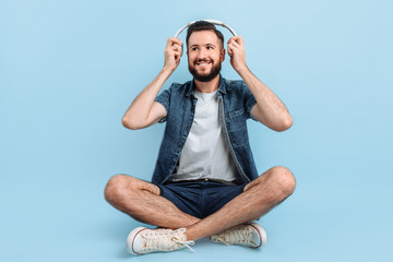 Wall Mural - A man listens to music with headphones