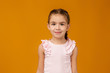 © producer - Cute smiling little child girl looking to camera on pink background. Human emotions and facial expression