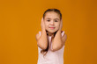 © producer - Little child girl covering her ear with her hand. I hear nothing