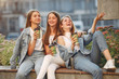© hetmanstock2 - Beautiful girls sitting. Women in a spring city. Ladies drinking a coffee.
