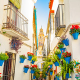 Fototapeta Uliczki - Mezquita tower and narrow spanish street Calleja de las Flores in Cordoba