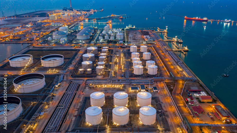 Aerial view oil and gas terminal storage tank farm,Tank farm storage chemical petroleum petrochemical refinery product, Business commercial trade fuel and energy transport by tanker vessel. - obrazy, fototapety, plakaty 