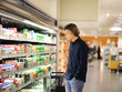 © lado2016 - Teenager shopping in supermarket, reading product information