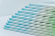 © elixirfoto - a large stack of blue-green books lies on a white surface. finished products of printed photobooks on a light background