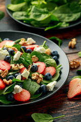 Wall Mural - Spinach, Strawberry, blueberry salad with walnut and feta cheese. Summer healthy food