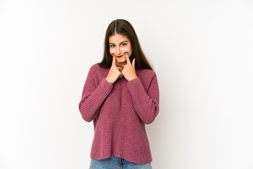 Wall Mural - Young caucasian woman isolated on white background doubting between two options.