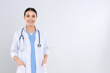 Portrait Of Young Doctor With Stethoscope On White Background