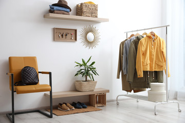 Hallway interior with stylish furniture, clothes and accessories