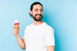 © Asier - Young caucasian man eating an ice cream isolated looks aside smiling, cheerful and pleasant.
