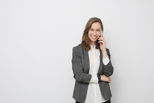 Happy Beautiful Businesswoman Is Talking On The Phone On A White Background