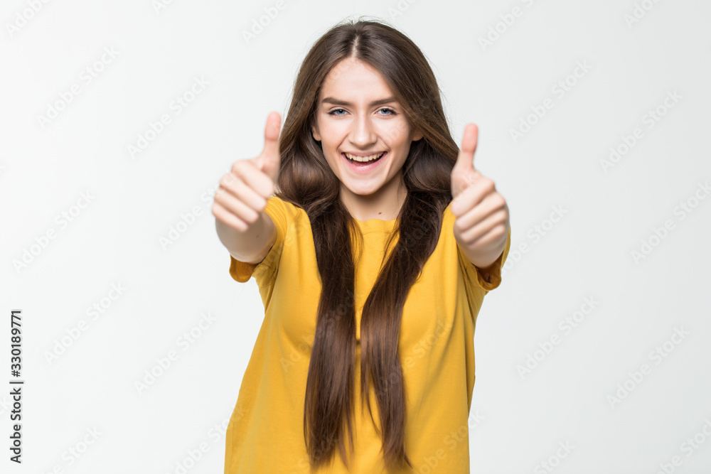 Happy beautiful girl showing thumbs up symbol by two hands isolated on ...