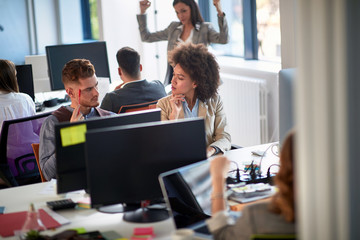 Wall Mural - Young business people in office. Colleagues in office. Businesswoman and businessman discussing work in office. Man and woman  working together.