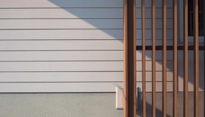 Wall Mural - Sunlight and shadow on surface of  wooden lath in front of white artificial wood and gray Sheetrock wall with part of glass window frame, cheap house materials prices in home architecture concept