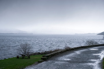 Wall Mural - Water flood at lake rough water waves over park at Loch Lomond Balloch uk