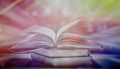 Poster - Imagine opening an old book blurred with magic power on the table and the English alphabet floating above the book with magic light as a beautiful background design.