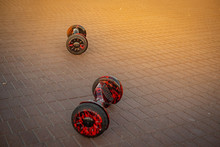 Two Hoverboard On The Cobblestones On A Sunny Summer Day. Hire Of Hoverboards