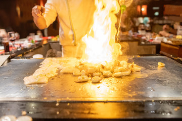 Wall Mural - Teppanyaki Chef Cooking Japanese Seafood Shrimp With Fire