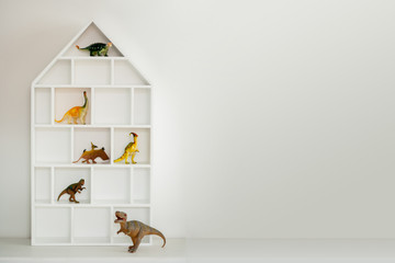 Toy dinosaur storage house shelf . Boys bedroom. Boyhood. Childhood with copy space.