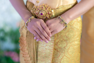 Thai people wear Thai traditional clothes for religious ceremonies or the wedding day of lovers. Golden Thai dress