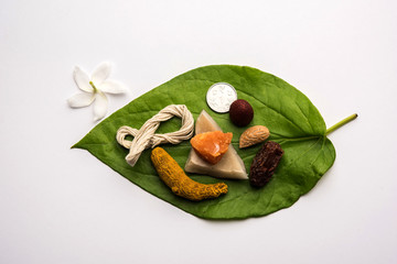 Hindu Puja with betel leaf, supari, janeu, almond, dates, turmeric, dried coconut and jaggery with 1 rupee coin. Important item in Vedic rituals. selective focus