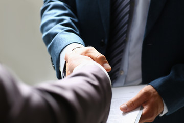 Man in suit shake hand as hello in office closeup. Friend welcome, mediation offer, positive introduction, greet or thanks gesture, summit participate approval, motivation, strike arm bargain concept