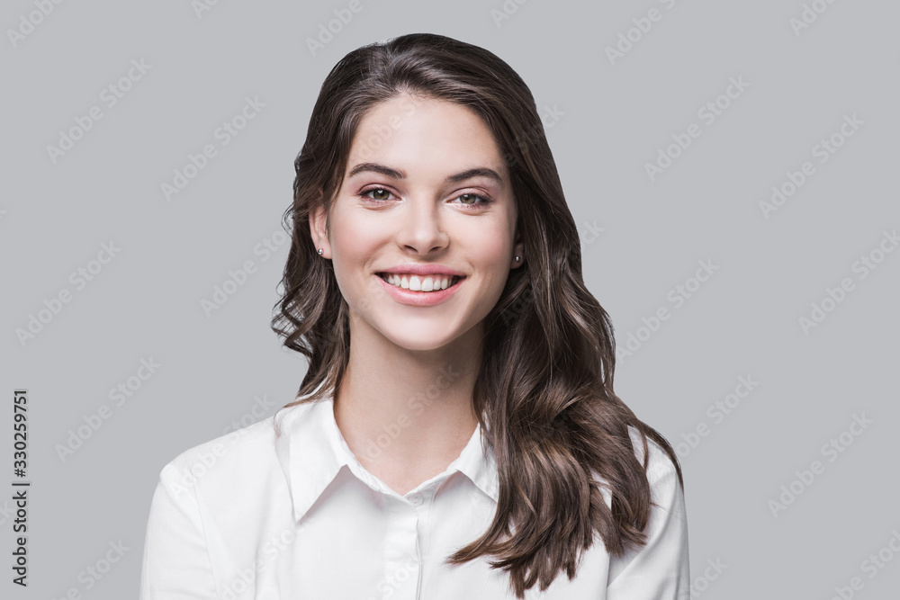 Beautiful young business woman portrait, Smiling cute girl with long hair studio shot, Isolated on gray background	 - obrazy, fototapety, plakaty 