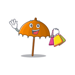 Canvas Print - Happy rich orange umbrella mascot design waving and holding Shopping bag