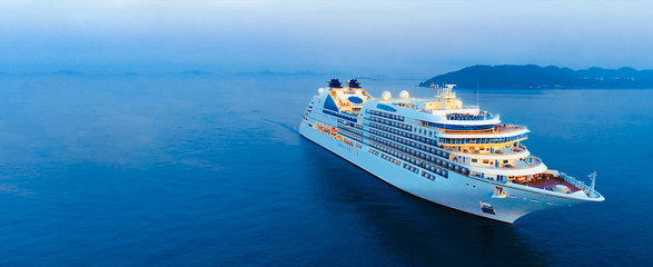 Wall Mural - aerial view of beautiful white cruise ship above luxury cruise in the ocean sea at early in the morn