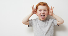 Redhead Child And Boy Being Silly And Having Fun In Front Of Camera, Showing Silly Face And Emotions 