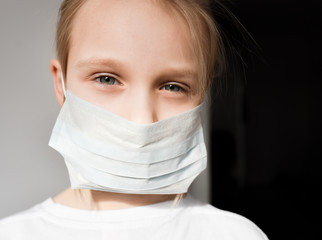 portrait of a child in a medical mask close up