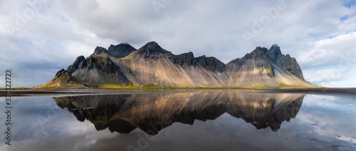 Beautiful shot of a mountain reflected on the water in Stokksnes, Iceland © Wirestock 