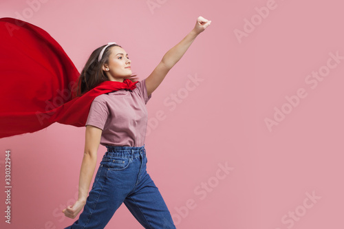 Superheroine, a young female superhero in a red Cape Poster Mural XXL