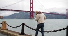 A Young Blonde Woman Walking With A Beautiful View Of The Golden Gate Bridge In San Francisco.