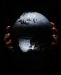 © Alex Tihonov - Hands of little girl hold globe sphere map isolated on black background.  COVID-19 pandemic infection disease. Environmental pollution, ecological disaster our kids and future planet concept BW image