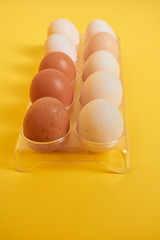 eggs in carton. Eggs on yellow background. Set of Eggs