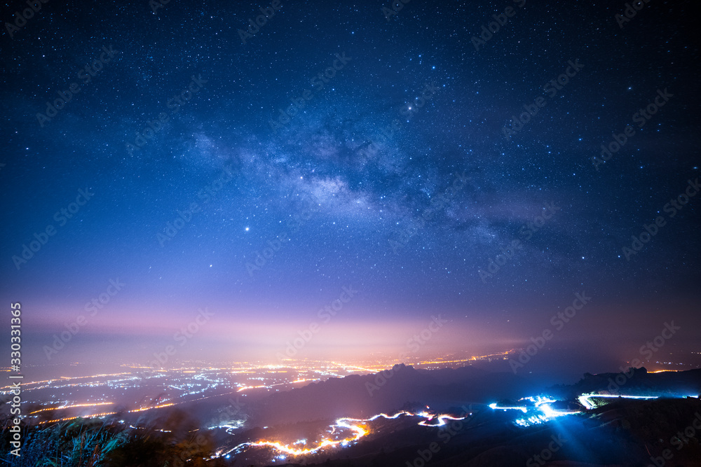 Night sky with milky way and stars. Night road illuminated by car ...