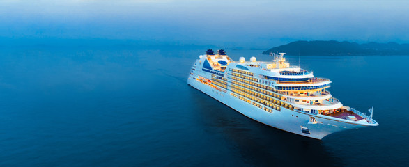 aerial view of beautiful white cruise ship above luxury cruise in the ocean sea at early in the morn
