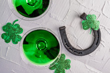 St. Patrick's Day Concept. Green Drink, Green Cocktail In A Glass, Horseshoe And Clover Leaf